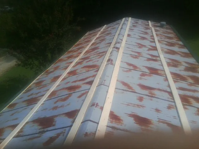 Rusted metal roof panels with new wood purlins before replacement — Storm Damage Roof Repair in Poteet by Roofing Brothers